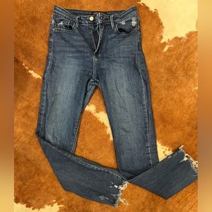 Distressed “just black” blue jeans with frayed edge